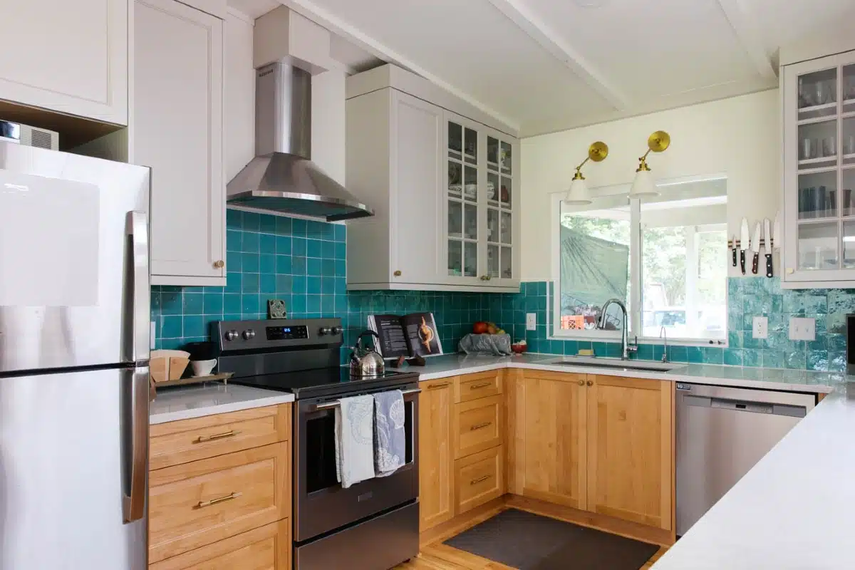 Kitchen with oak cabinets and turquoise tile, remodeled after storm damage